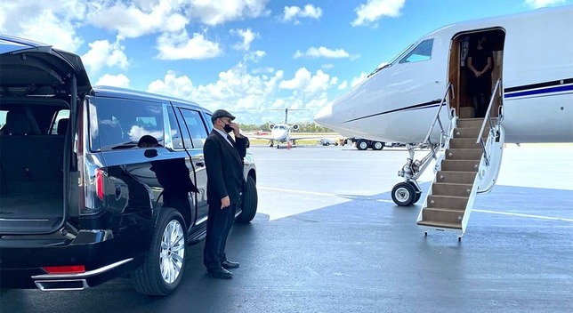 an SUV with a shofar next to a privet jet